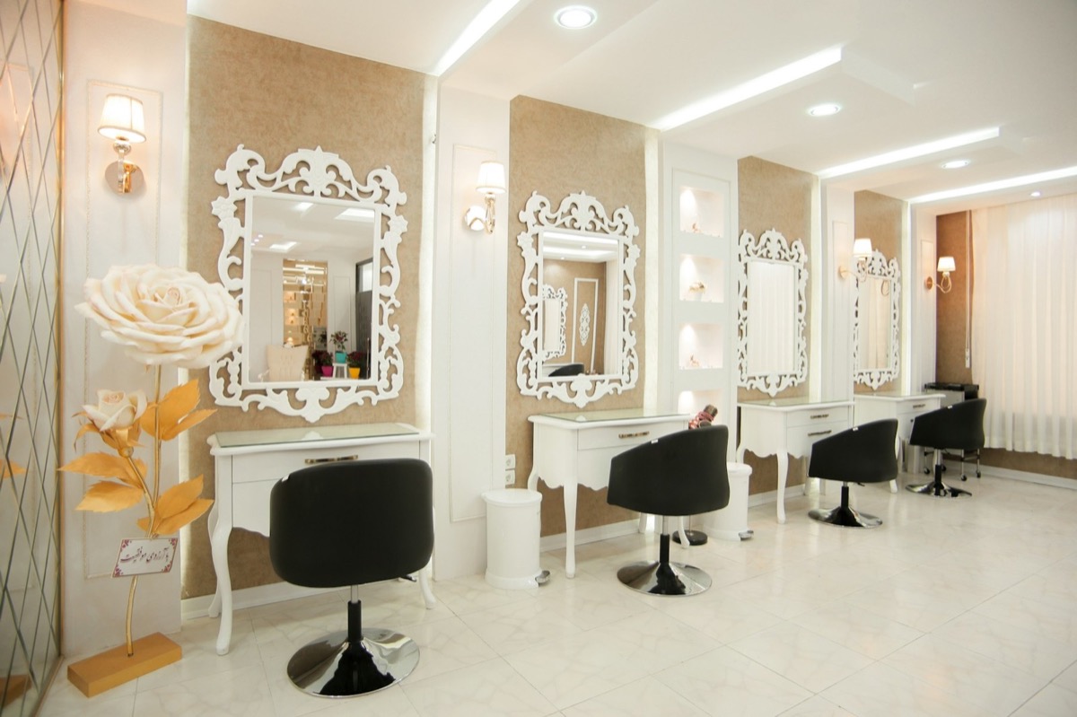 Warm modern hair salon interior with styling chairs